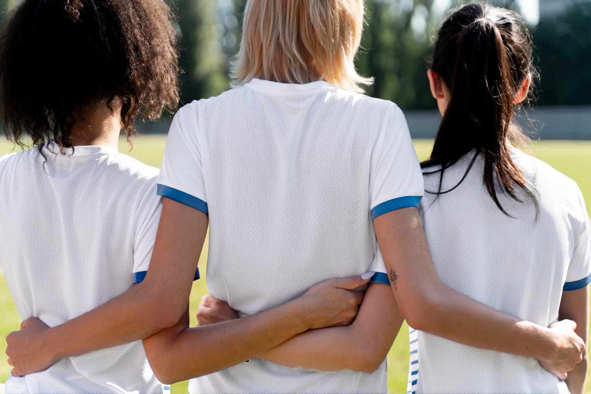 Close up view of custom uniforms for softball with team colors and numbers.